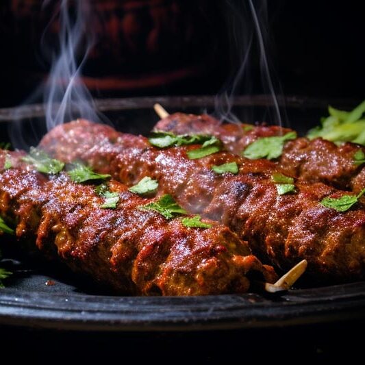 Our-Food-(Large)-lcartwork_seekh_kebab_on_a_dark_plate_90fcb236-9a9a-4a20-8c96-b28303d31737